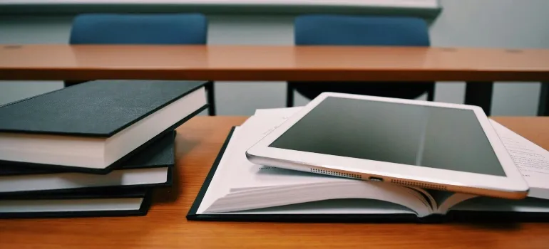 Silver Ipad on White Book Page