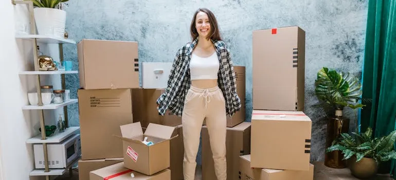 a person standing in front of their boxes