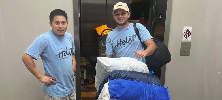 Professional movers carrying various items during a move.