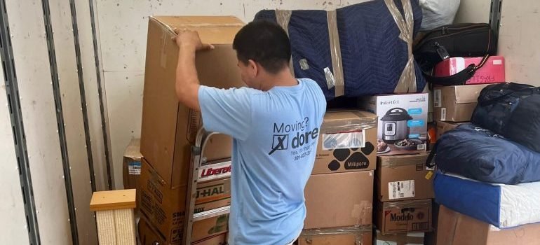 A professional mover loading a moving truck.