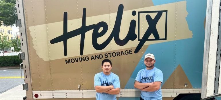 Movers in front of a moving truck.