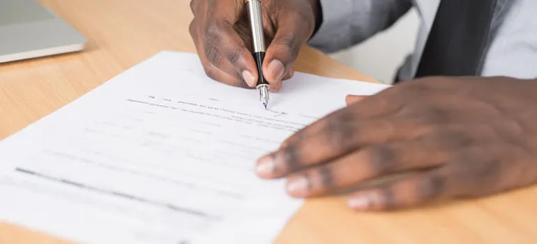 A person signing a document.