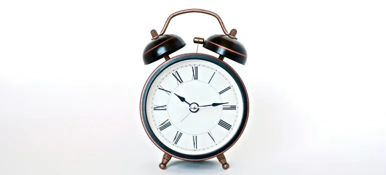 An alarm clock on a white surface.