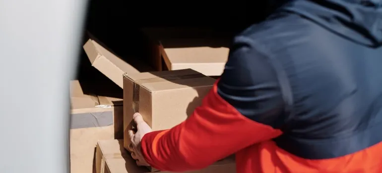 Person loading boxes into a van.