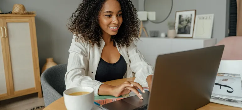 A woman using a laptop to find some tips on sdjusting to slower living in Maryland countryside.