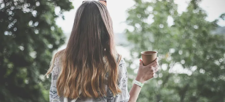 A woman having a coffee and observing the scenery.